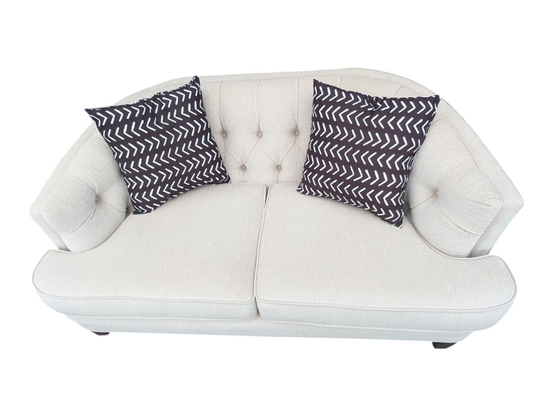 Cream Curved Tufted Sofa with Accent Pillows